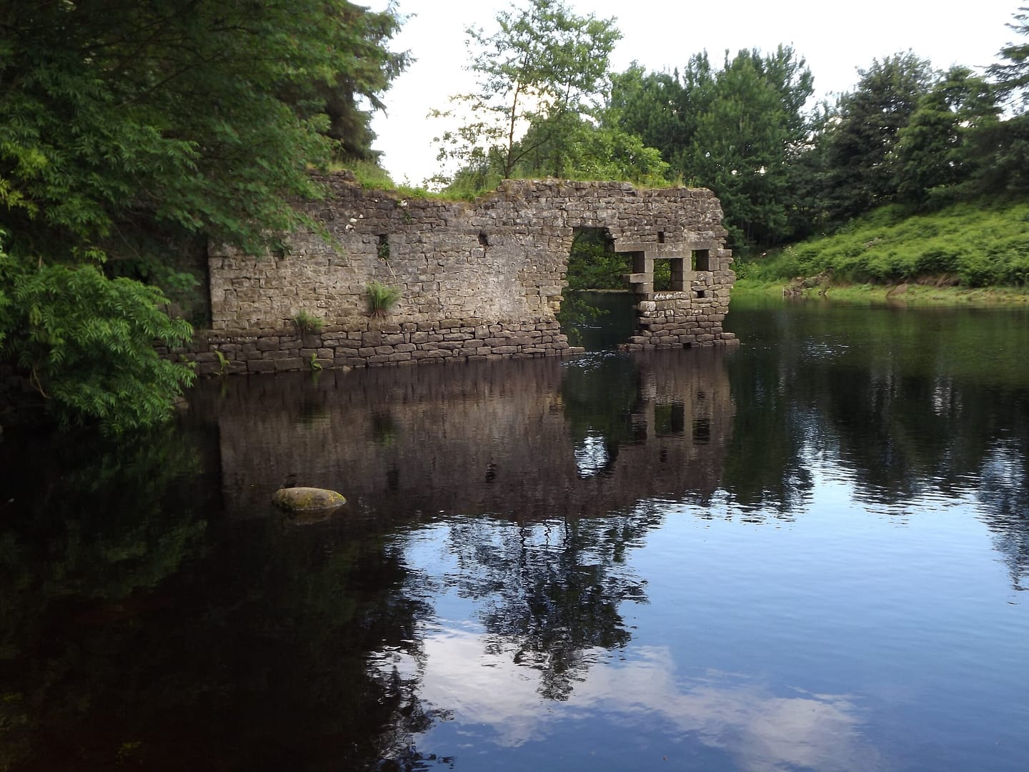 Archaeology in the woods around Yorkshire reservoirs Yorkshire reservoir with ruined building
